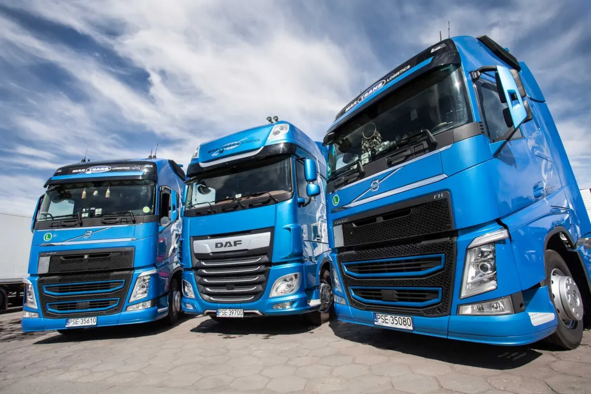 Trzy niebieskie ciągniki siodłowe Volvo i DAF z floty MAR-TRANS